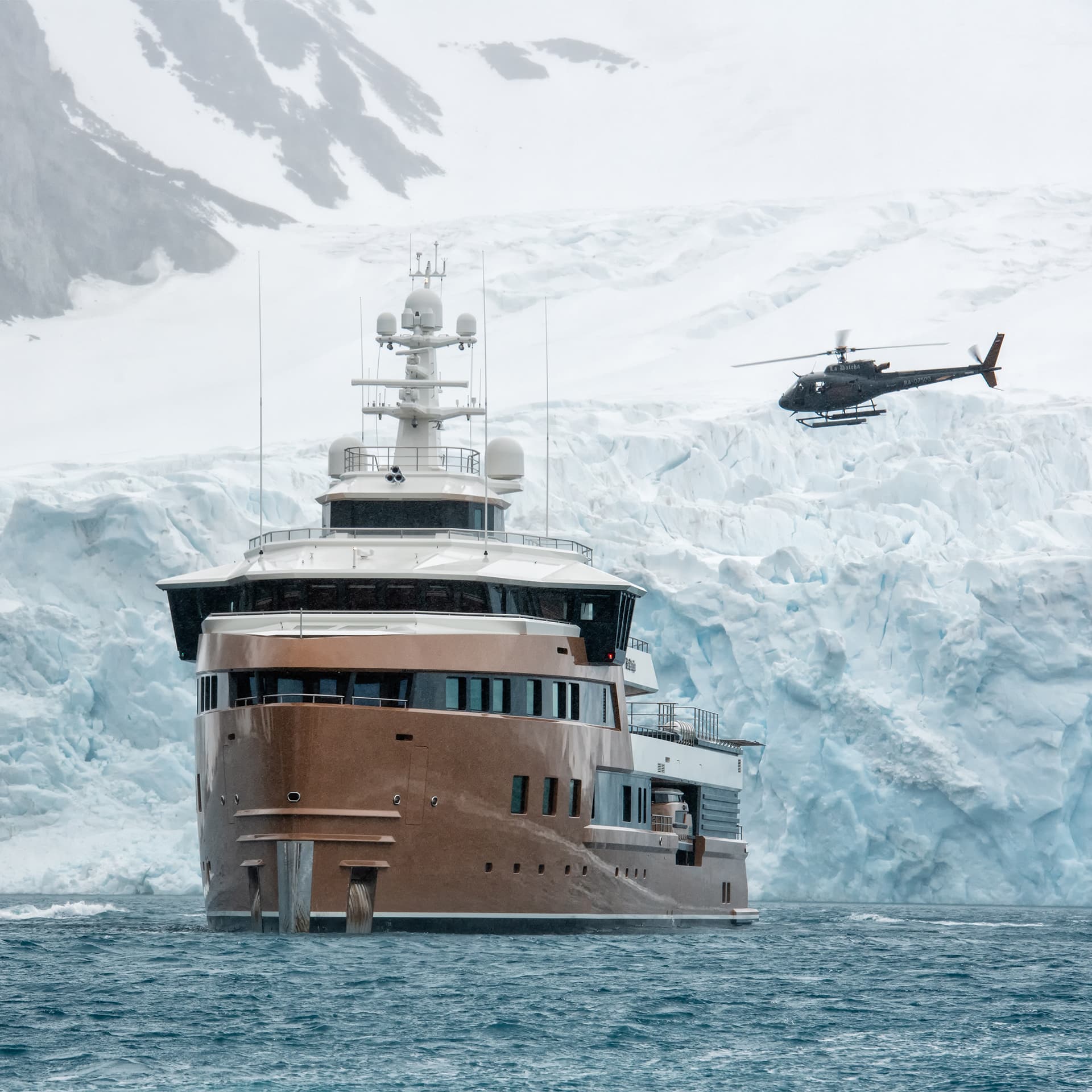 M/Y La Datcha bow with helicopter against glacier wall